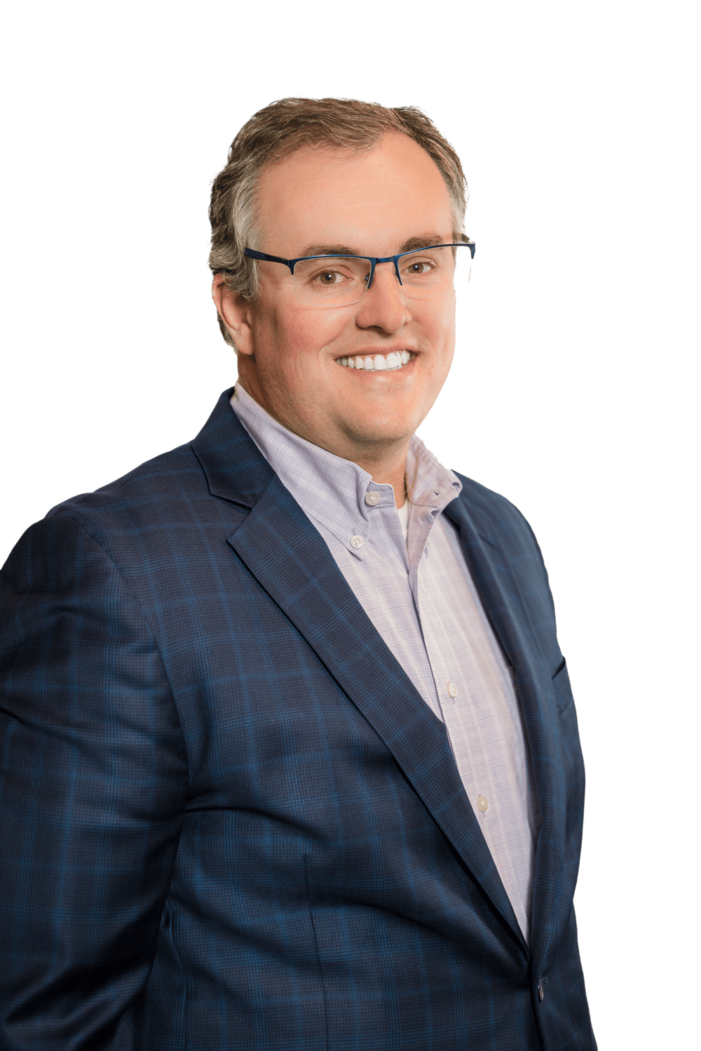 A man with short light brown hair and glasses, wearing a blue plaid suit jacket and a light-colored button-up shirt, smiles at the camera against a plain background, reflecting the professionalism of Colorado engineering.