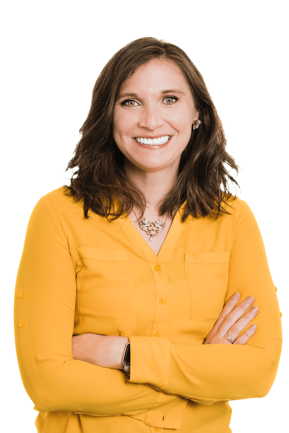 A woman with shoulder-length brown hair, wearing a yellow blouse and a necklace, smiles with her arms crossed—confident in her role as a Colorado engineering professional.