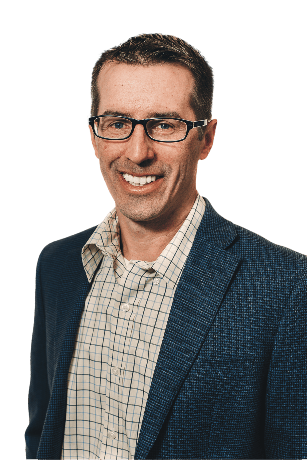 A man wearing glasses, a blue textured blazer, and a checked dress shirt smiles at the camera against a plain green background, reflecting the professional style of a Denver engineer.