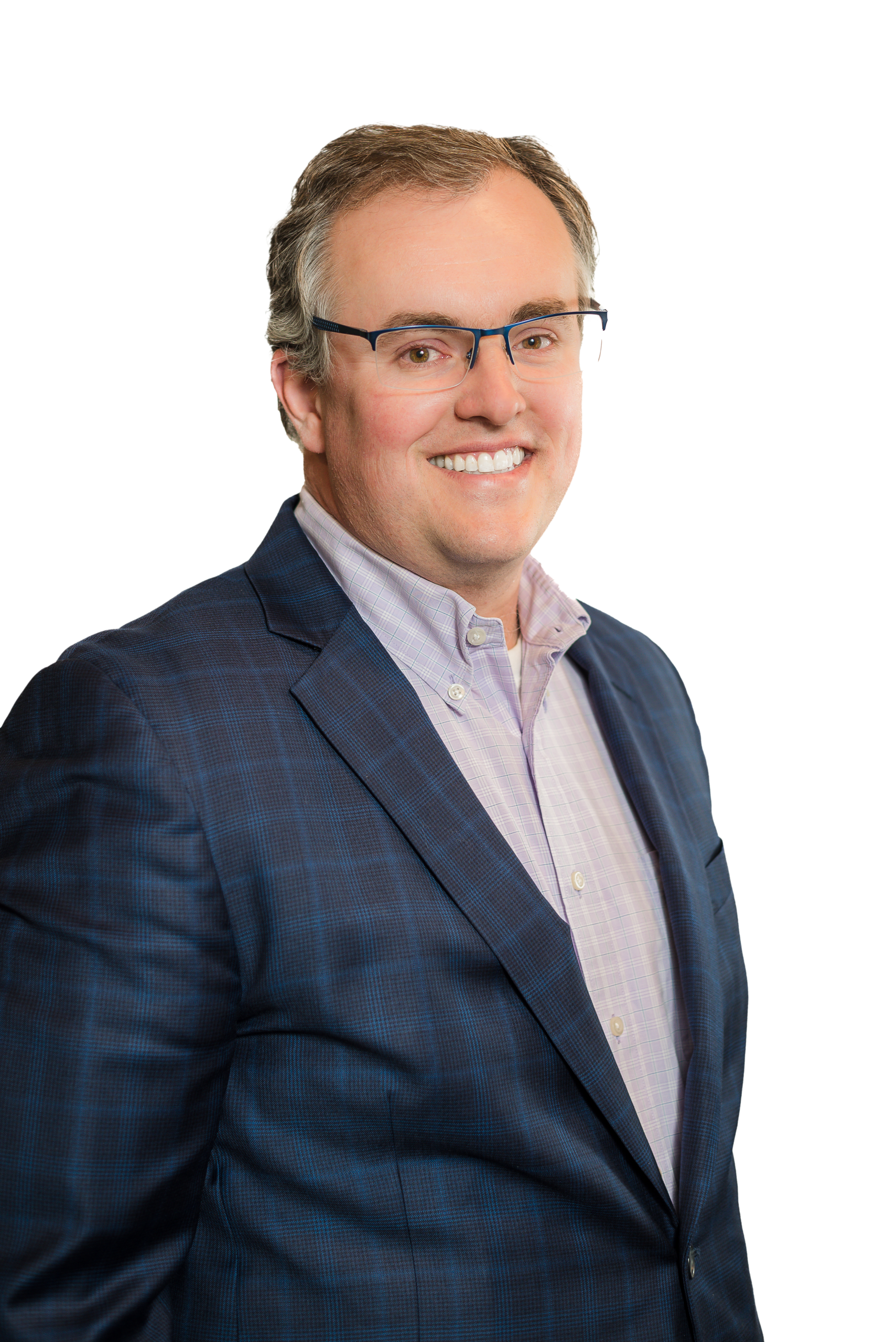 A Denver engineer with short light brown hair and glasses, wearing a blue checked suit jacket over a pale button-up shirt, smiles at the camera against a plain background.