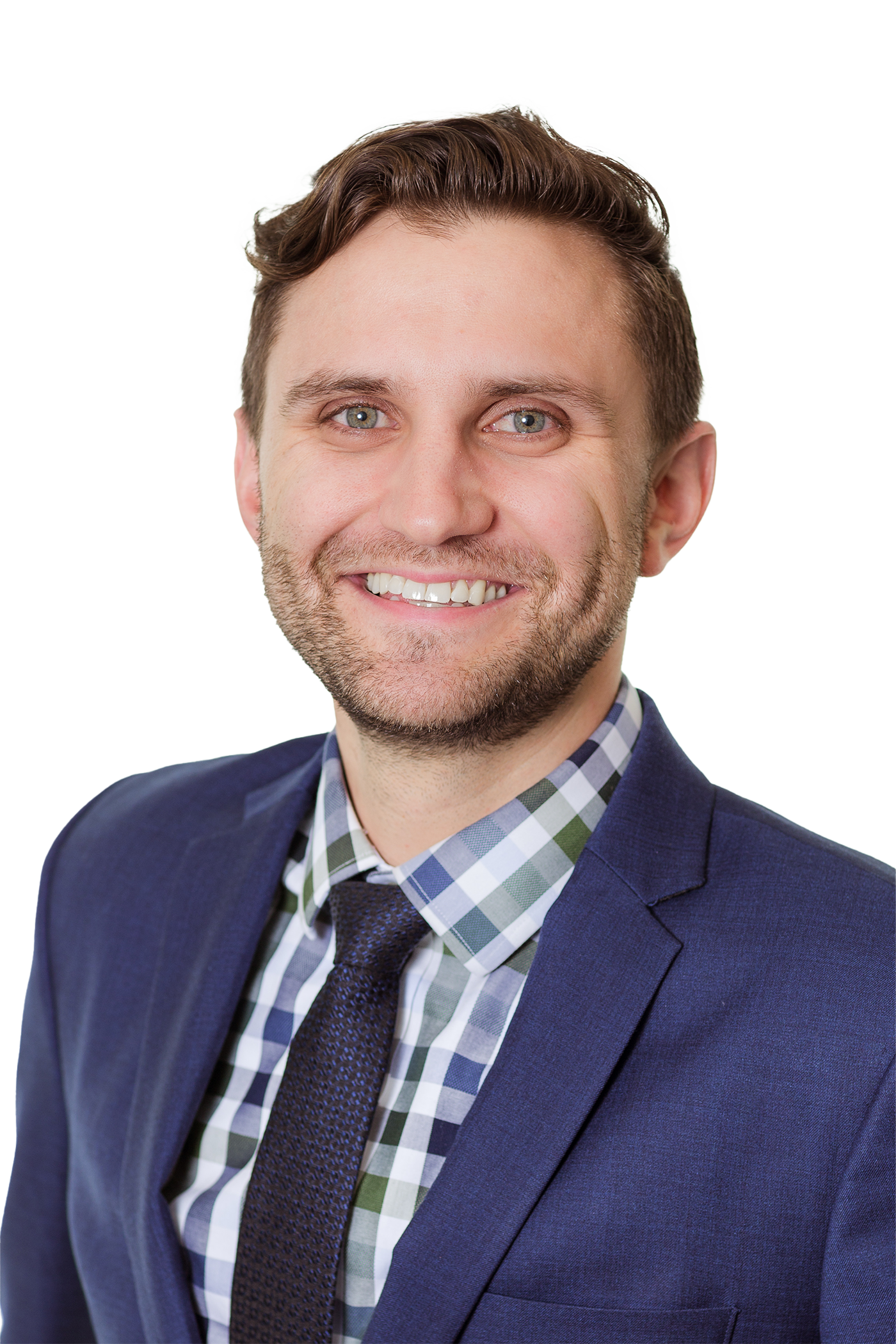A smiling man with short brown hair and a trimmed beard, dressed in a blue suit jacket, checkered shirt, and dark tie, poses confidently against a plain white background—showcasing the professionalism of a Colorado engineering expert.