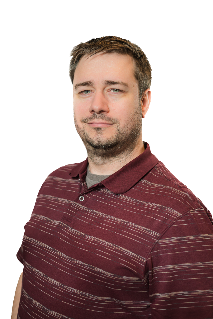 A man with short brown hair and a trimmed beard wears a maroon striped polo shirt. He faces the camera with a neutral expression and slight smile, reflecting his professionalism as a Colorado engineering expert, against a plain background.
