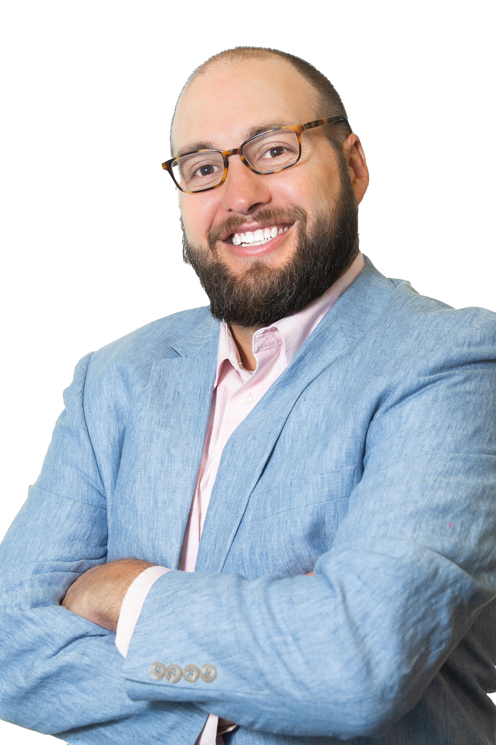 A smiling man with glasses, a beard, and mustache wears a light blue blazer over a light pink shirt. He stands with arms crossed, confidently representing Colorado engineering. The background is plain and transparent.
