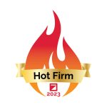 A stylized red and orange flame with a gold ribbon that reads Hot Firm. Below the flame is a red square logo and the year 2023 in red text, representing excellence in Colorado engineering. The background is white.
